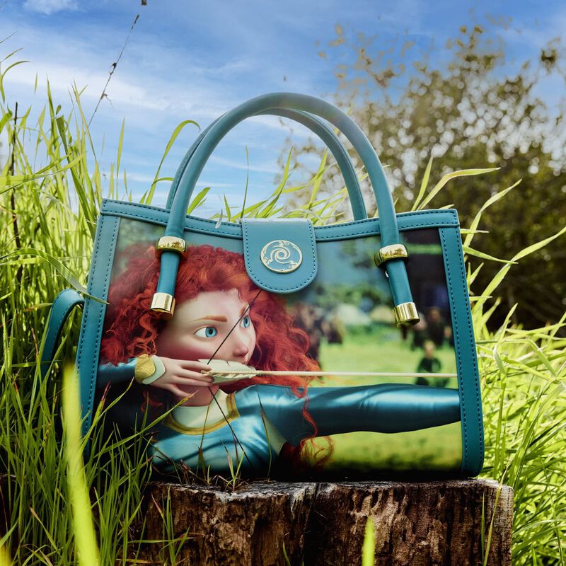 Blue handbag with a character design on grass