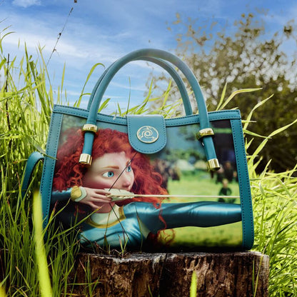 Blue handbag with a character design on grass