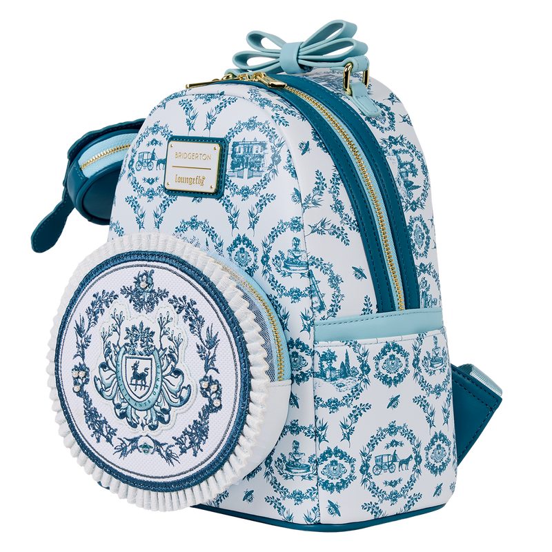 Blue and white patterned backpack with a decorative emblem on a white background
