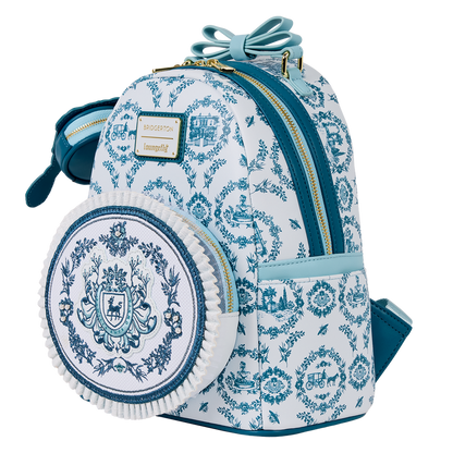 Blue and white patterned backpack with a decorative emblem on a white background