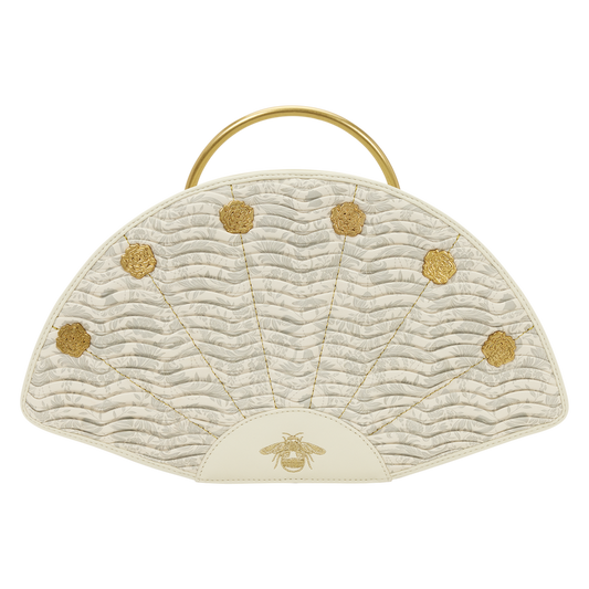 Beige handbag with gold accents and a bee emblem on a white background
