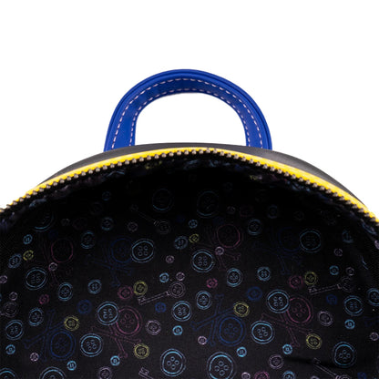 Close-up of a black backpack with colorful button pattern on a white background