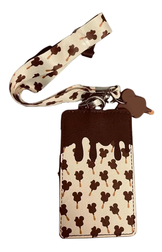 A chocolate-drip style phone pouch with a matching wrist strap, featuring a cream background with brown Mickey Mouse head and Mickey Mouse ice cream cone patterns, and a solid dark brown top section.