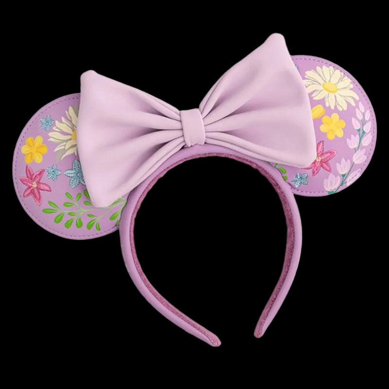 Pink mouse ears with a large bow and floral designs on a white background