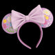 Pink mouse ears with a large bow and floral designs on a white background