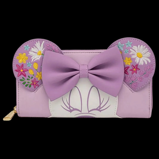 A lavender and white wallet styled like Minnie Mouse's head, featuring a large lavender bow on the front, floral embroidery on the mouse ears, and a gold zipper pull on a white background.