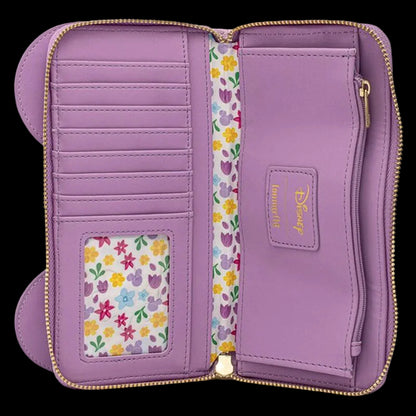 A lavender purple zip-around wallet shown open, featuring multiple card slots, a floral-patterned ID window, a matching floral lining, and a gold-tone Disney logo patch on the right interior pocket.