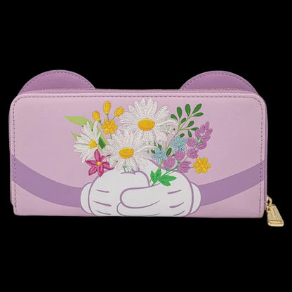 A lavender purple zip-around wallet with cat-ear cutouts on the top, featuring a white gloved hand holding a bouquet of colorful wildflowers. A gold zipper pull is visible on the right side.