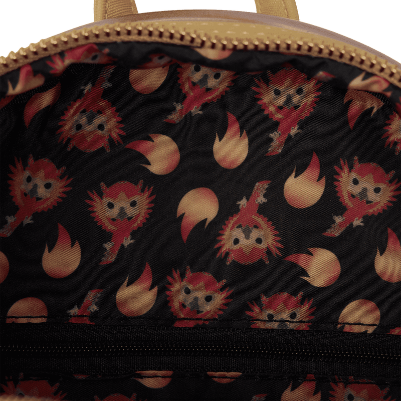 Close-up of a bag with a pattern of cartoon characters and flames on a black background.