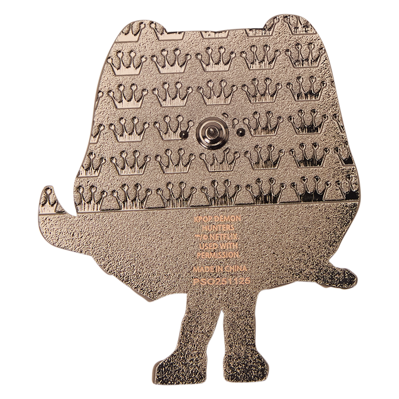 Bronze-colored metal template with engraved patterns on a white background