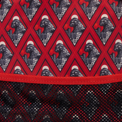 Close-up of a fabric with a red and black geometric pattern featuring a mountain and moon design.
