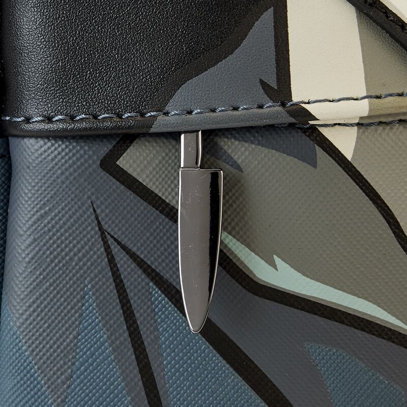 Close-up of a metallic clasp on a patterned bag