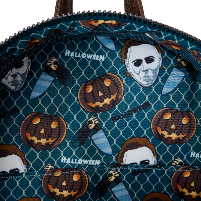 Halloween-themed bag with pumpkins and masks on a blue patterned background