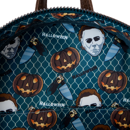 Halloween-themed bag with pumpkins and masks on a blue patterned background