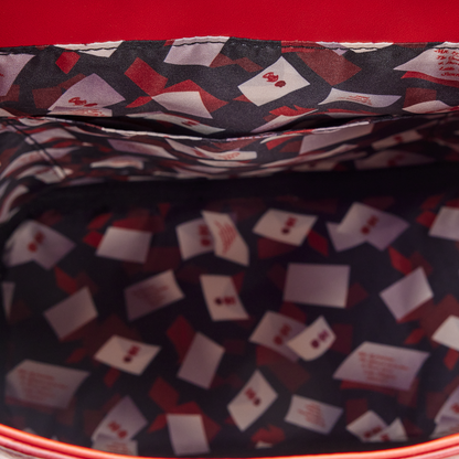 Close-up of a patterned fabric with red, white, and black colors on a red background.