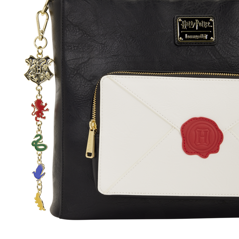 Black backpack with Harry Potter-themed design, including a charm and envelope pouch.
