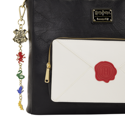 Black backpack with Harry Potter-themed design, including a charm and envelope pouch.