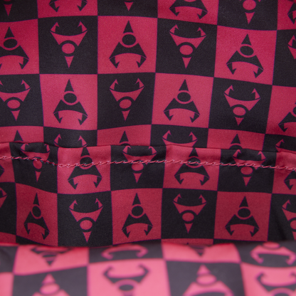 Red and black checkered pattern with a central logo on fabric