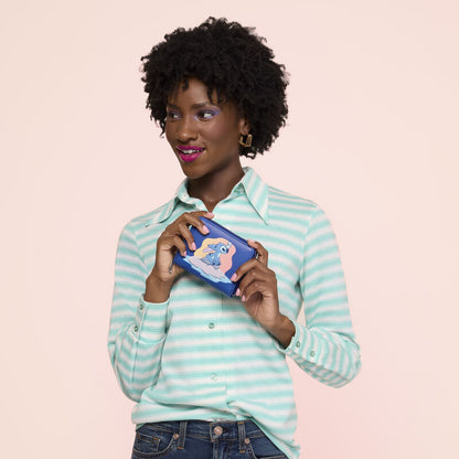 Woman holding a product against a light pink background