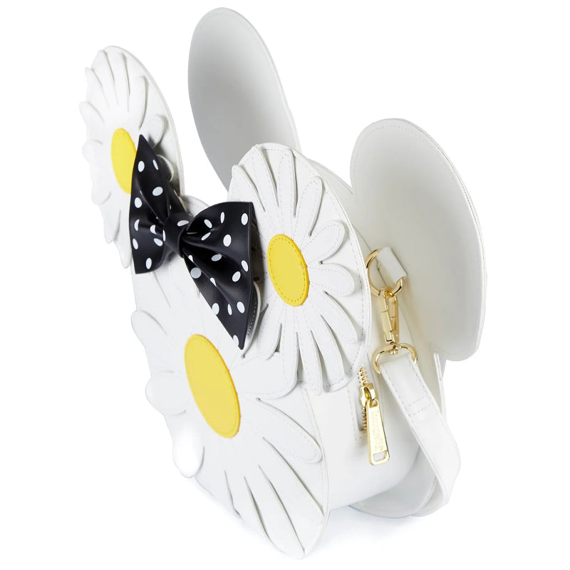 White handbag shaped like a flower with yellow centers and a black polka dot bow on a white background