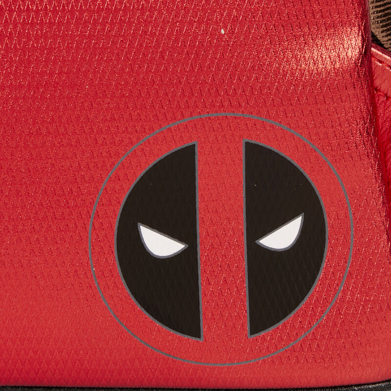 Close-up of a red surface with a black and white logo resembling a stylized face.