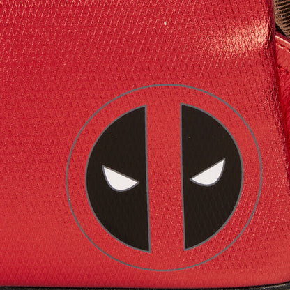 Close-up of a red surface with a black and white logo resembling a stylized face.