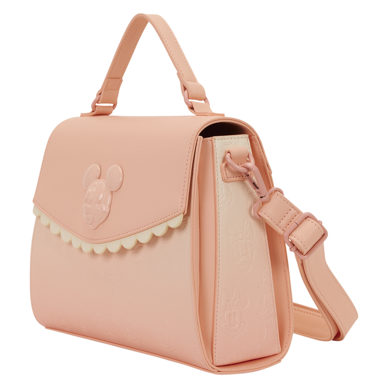 Pink handbag with a decorative flap on a white background