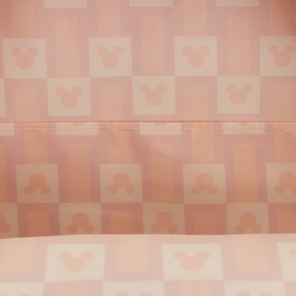 Checkered pattern with a stylized face design on a pink background