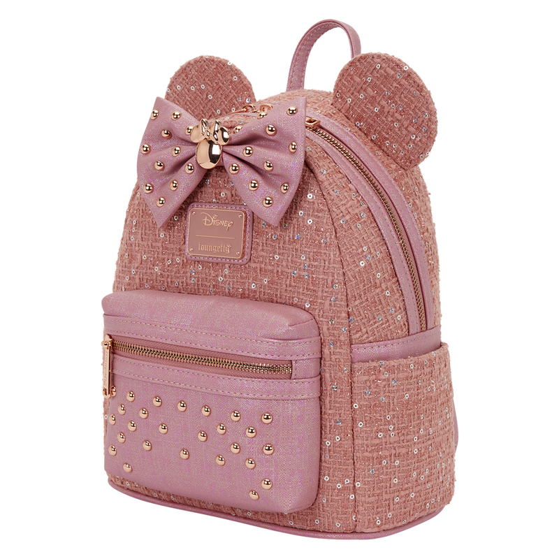 Pink backpack with gold accents and a bow, featuring the Disney logo.