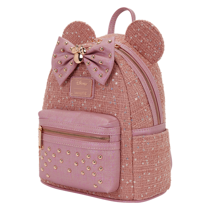 Pink backpack with gold accents and a bow, featuring the Disney logo.