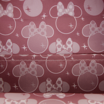 Pattern of Minnie Mouse heads with bows on a pink background