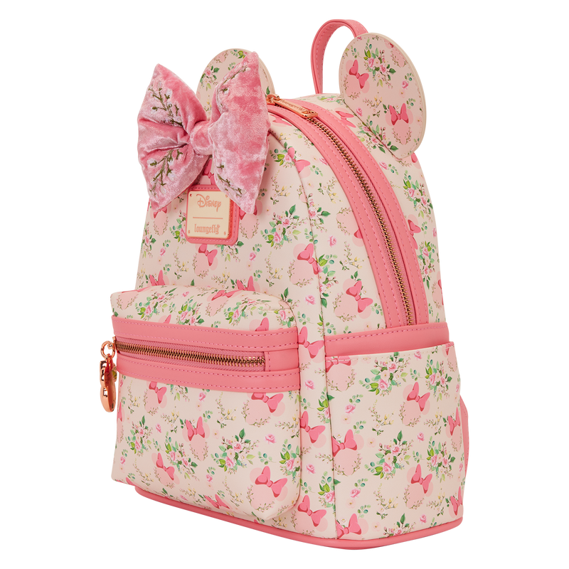 Pink backpack with floral pattern and bow design on a white background