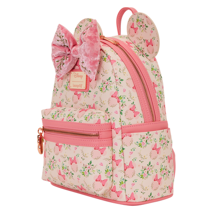 Pink backpack with floral pattern and bow design on a white background