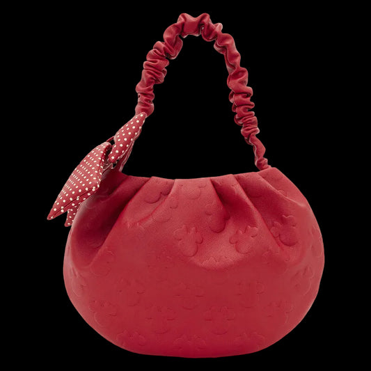 Red textured handbag with a ruched handle on a white background