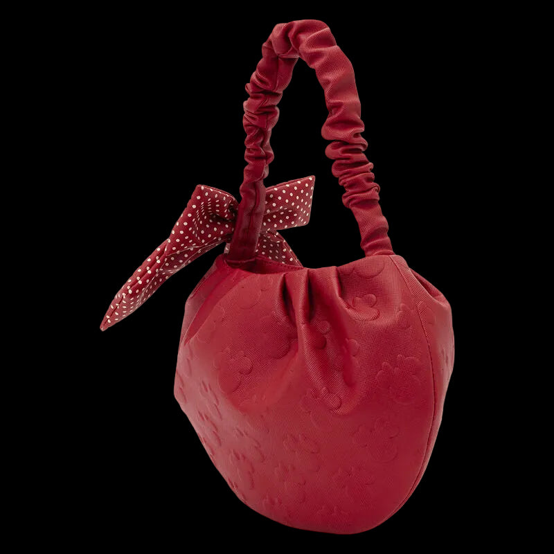 Red textured handbag with a bow on a white background