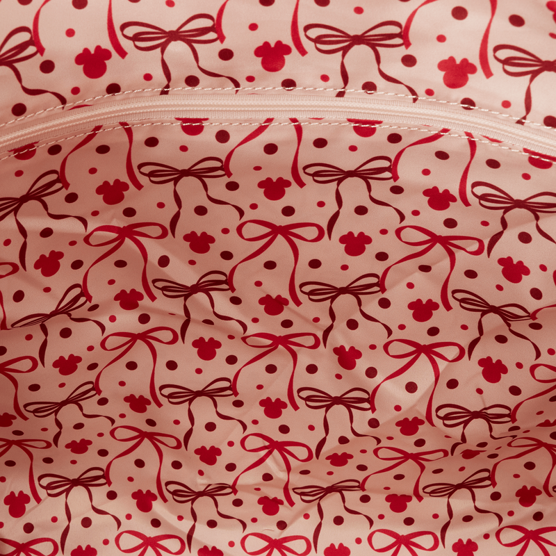 Close-up of a pink fabric with red bow and polka dot pattern