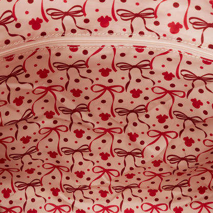 Close-up of a pink fabric with red bow and polka dot pattern