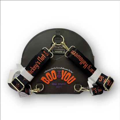 Black leather bag with Halloween-themed straps featuring text and graphics.