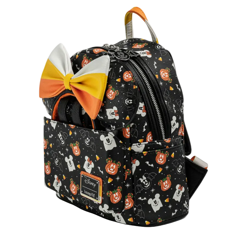 Backpack with Halloween-themed design and candy corn bow on a white background