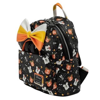 Backpack with Halloween-themed design and candy corn bow on a white background