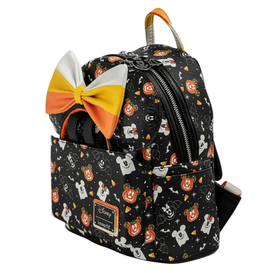 Backpack with Halloween-themed design and candy corn bow on a white background