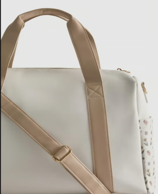 White bag with beige handle and strap on a light gray background