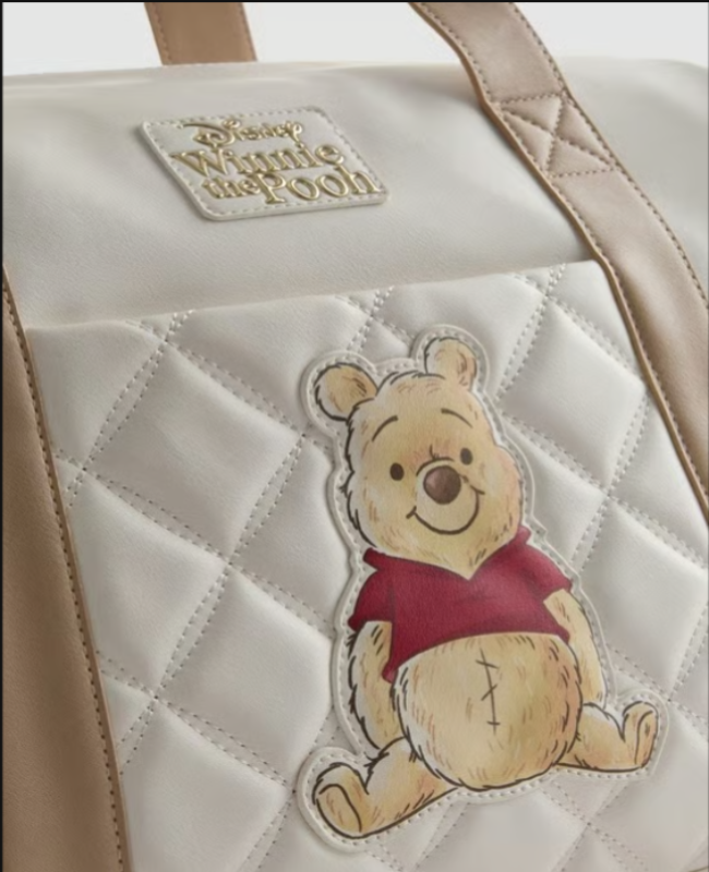Quilted bag with a patch of Winnie the Pooh on a beige background