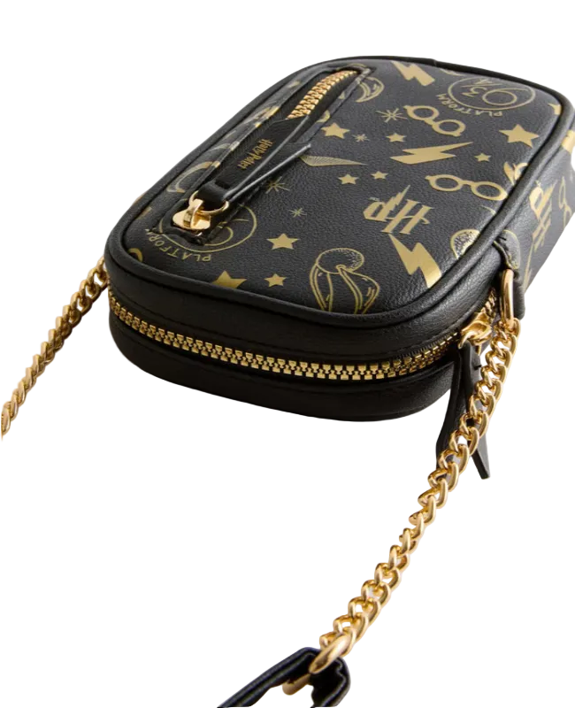 Black handbag with gold chain strap and detailed design on a light gray background