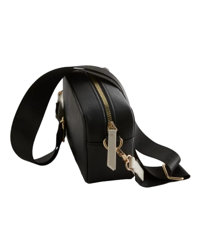 Black crossbody bag with a gold zipper on a light gray background