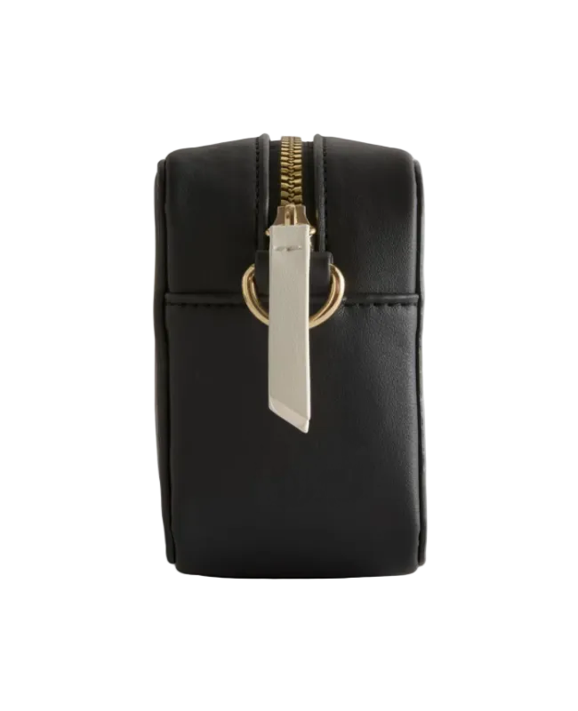 Black pouch with gold zipper and silver tag on a light gray background