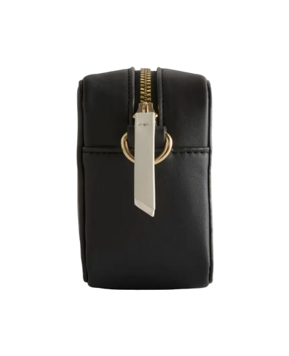 Black pouch with gold zipper and silver tag on a light gray background