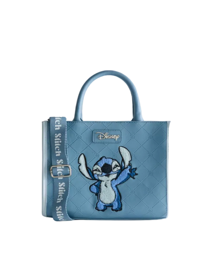 Blue quilted handbag with a character design on a light gray background
