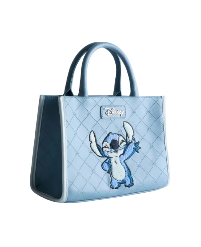 Light blue quilted handbag with cartoon character on a light gray background