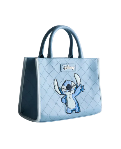 Light blue quilted handbag with cartoon character on a light gray background